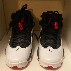 Black and White Sneakers with Red Accents