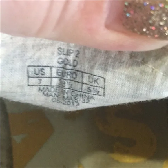 Gold slip on sneakers by Isaac Mizrahi