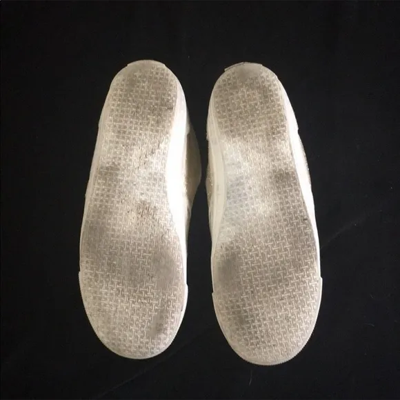 Gold slip on sneakers by Isaac Mizrahi