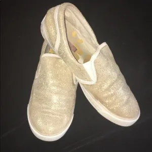 Gold slip on sneakers by Isaac Mizrahi