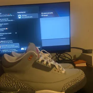 Gray and White Sneakers with Orange Accents
