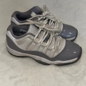 JORDAN 11 Retro Low Cement Gray and White Sneakers