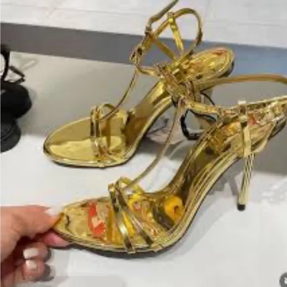 Metallic high-heel with ankle straps. Elegant Gold Stiletto Sandals.