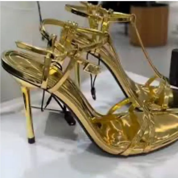 Metallic high-heel with ankle straps. Elegant Gold Stiletto Sandals.