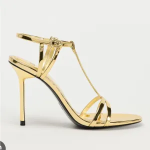 Metallic high-heel with ankle straps. Elegant Gold Stiletto Sandals.