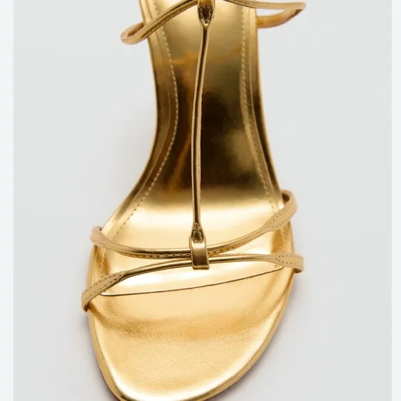 Metallic high-heel with ankle straps. Elegant Gold Stiletto Sandals.