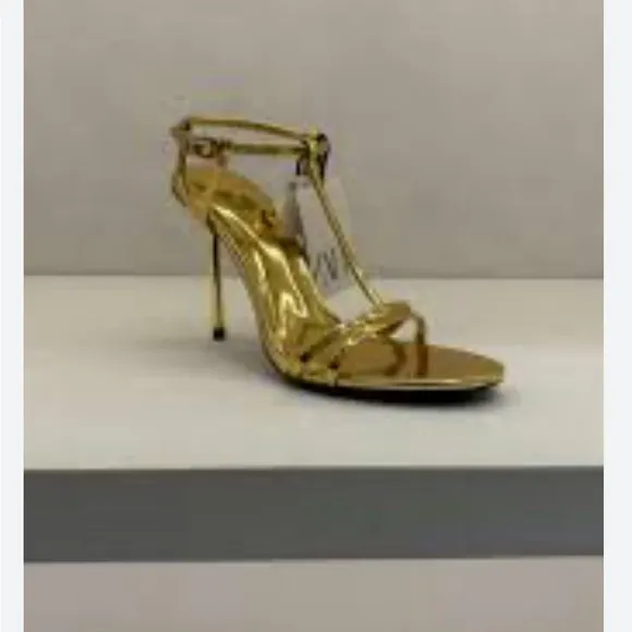 Metallic high-heel with ankle straps. Elegant Gold Stiletto Sandals.